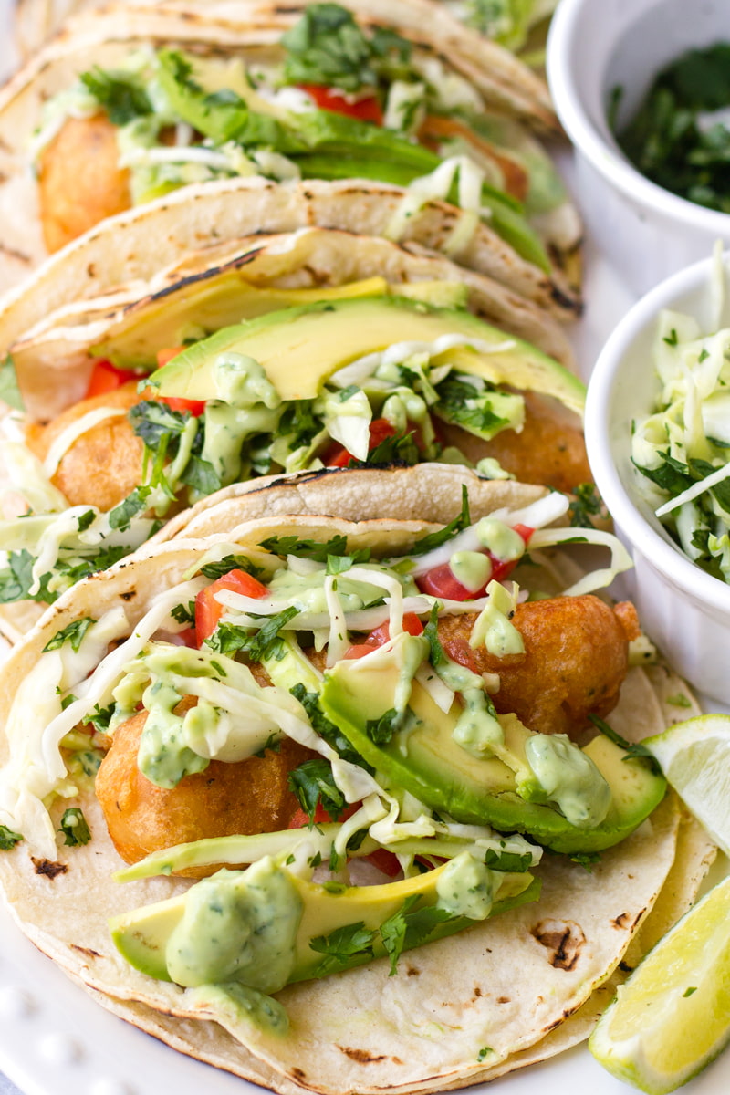 baja fish tacos with avocado and toppings
