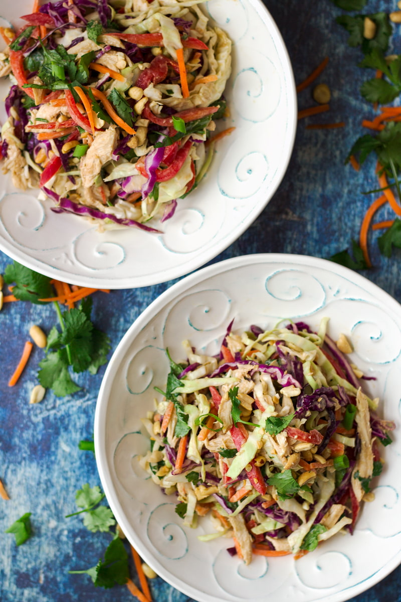 two bowls of asian chicken slaw salad