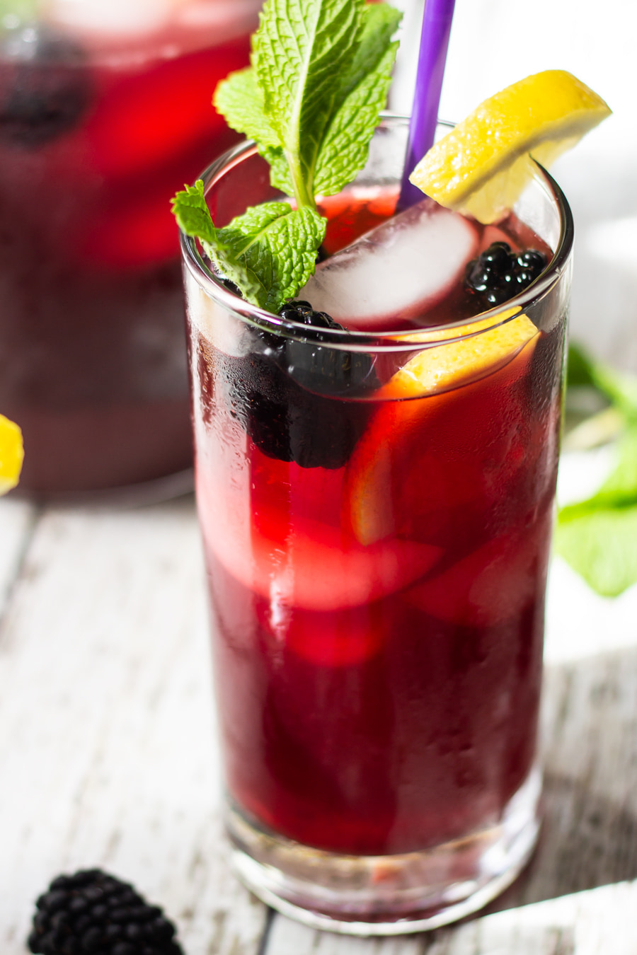 blackberry iced tea with whole blackberries in glass