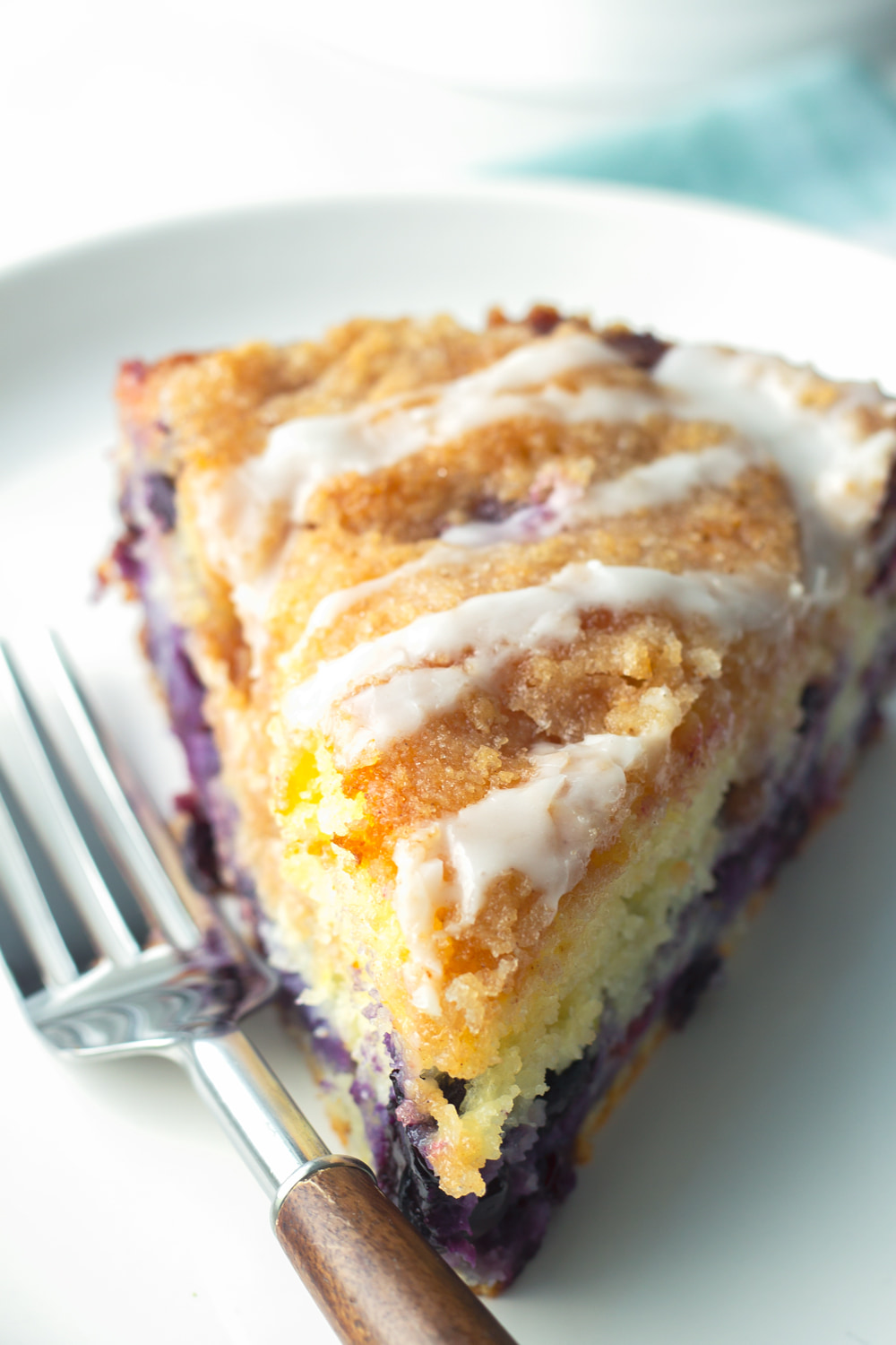 slice of blueberry coffee cake with lemon glaze