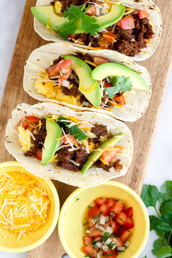 three mexican breakfast tacos with pico de gallo and cheese