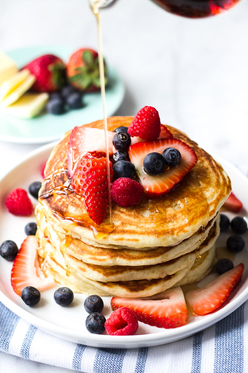light and fluffy buttermilk pancakes with berries and maple syrup