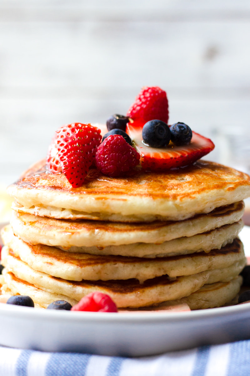 fluffy buttermilk pancakes with mixed berry topping