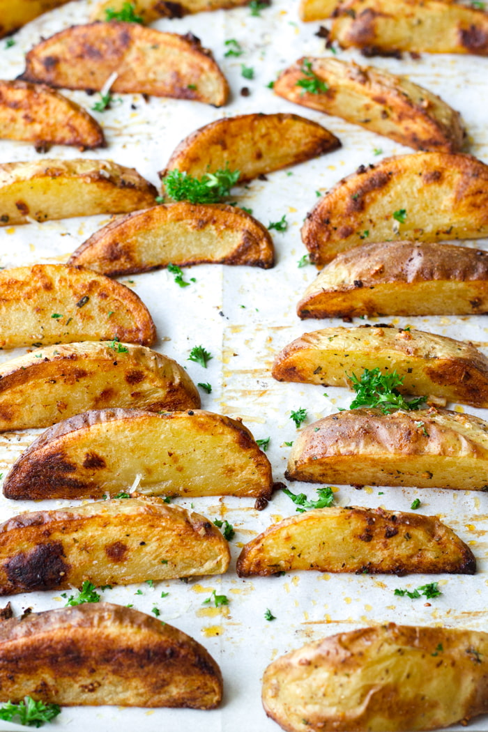 Extra Crispy Baked Garlic & Herb Potato Wedges - Baker by Nature