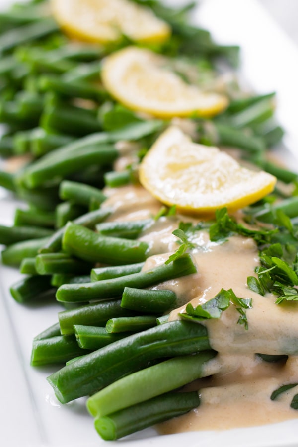 Large plate with green beans and lemon tahini sauce