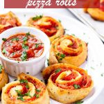 Ham and pepperoni pinwheels with marinara dipping sauce in the middle and parsley garnish