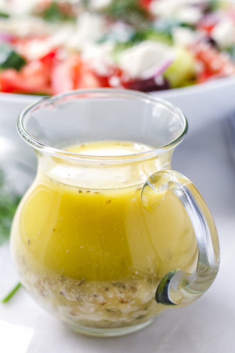 Little jar filled with Greek salad dressing