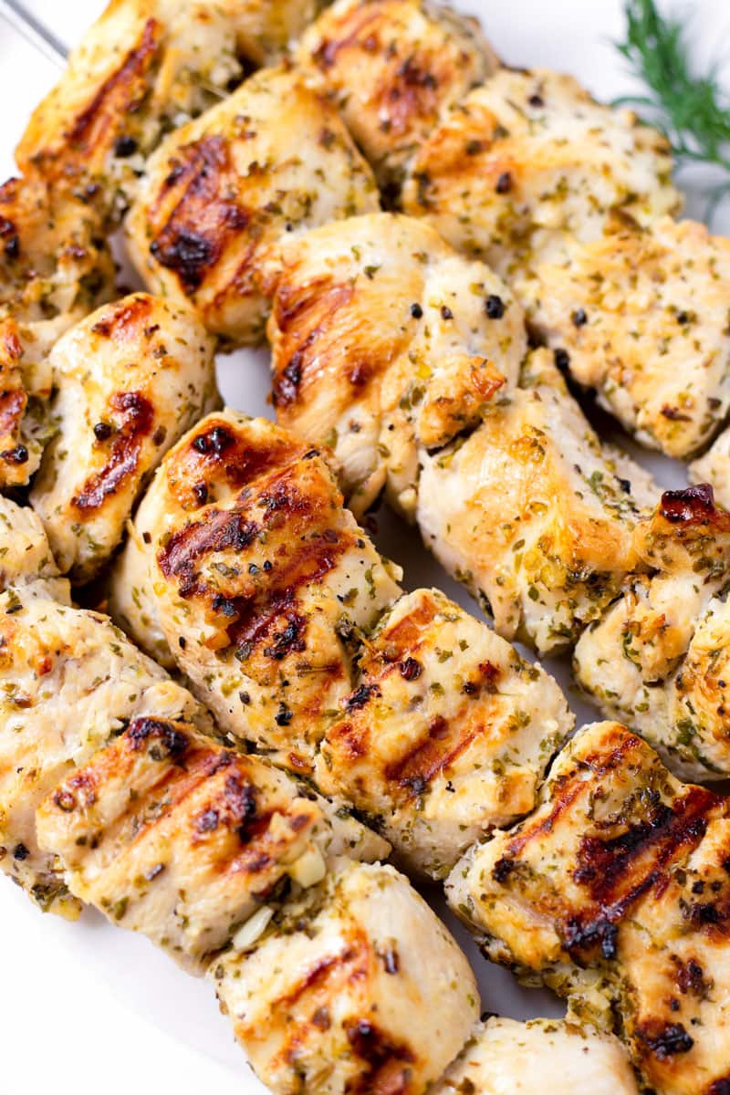 close up of grilled chicken kabobs in skewers
