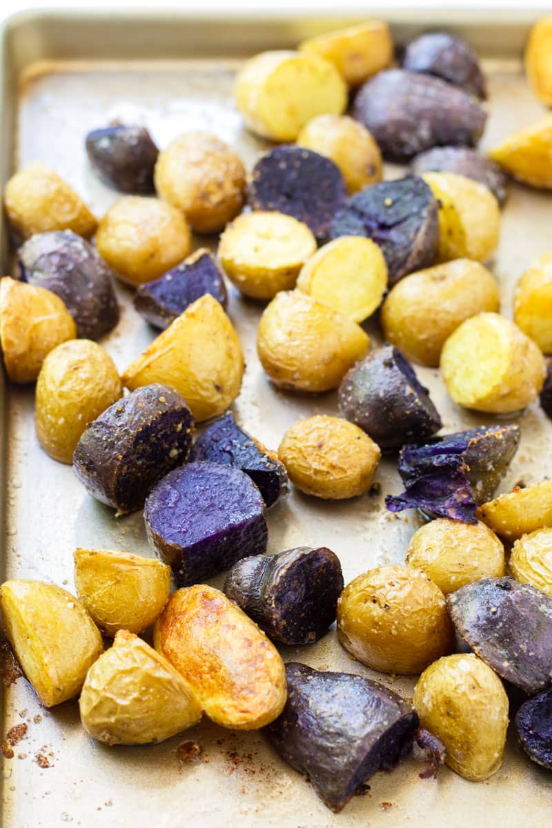 Sheet pan with roasted purple and yellow potatoes
