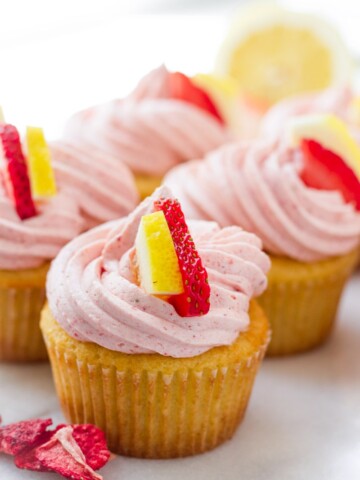 Strawberry lemonade cupcake decorated with a slice of lemon and strawberry
