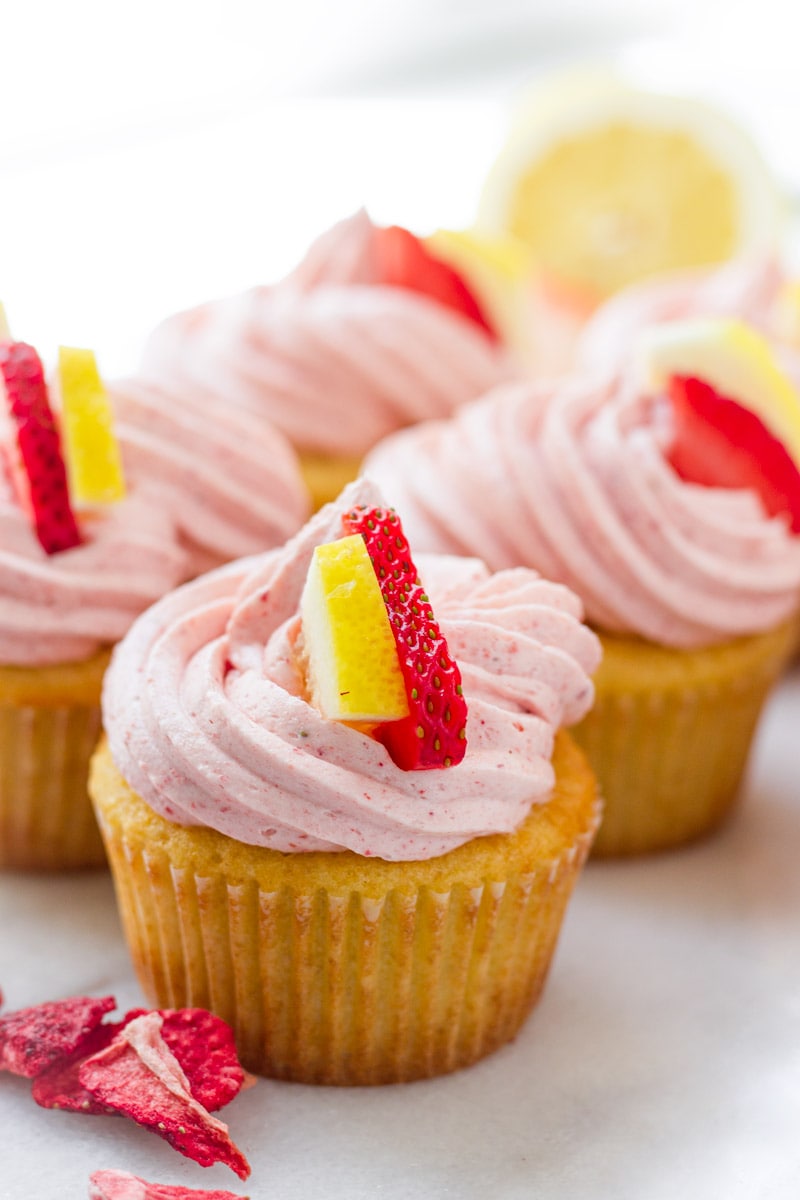 Strawberry lemonade cupcake decorated with a slice of lemon and strawberry