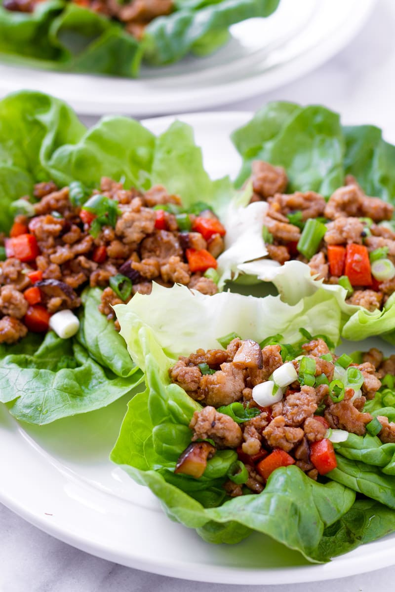 Three Asian lettuce wraps on white plate