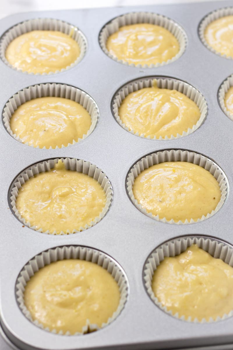 Prepared muffin tin with liners and filled with batter