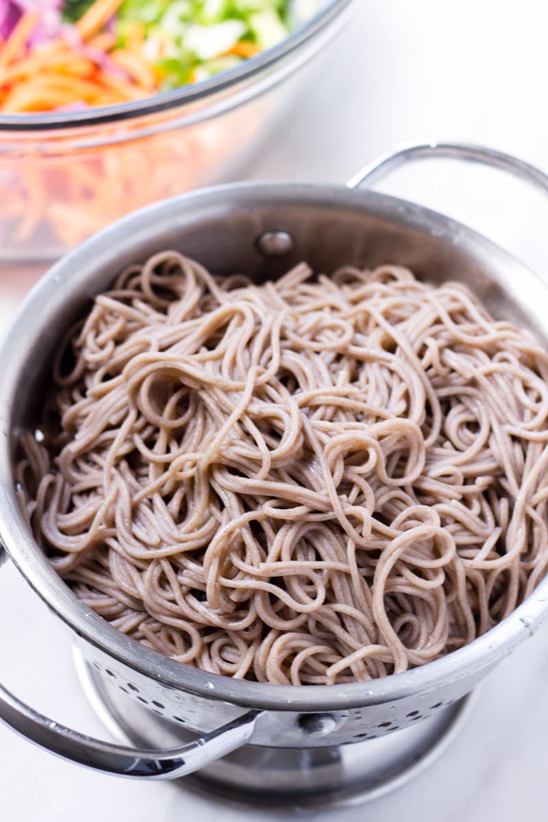 cooked and drained buckwheat noodles in colander