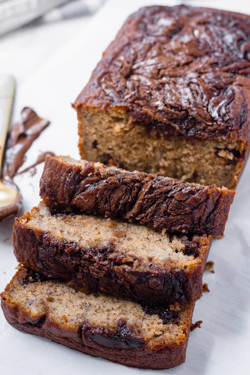 sliced loaf of nutella banana bread with spoon in background