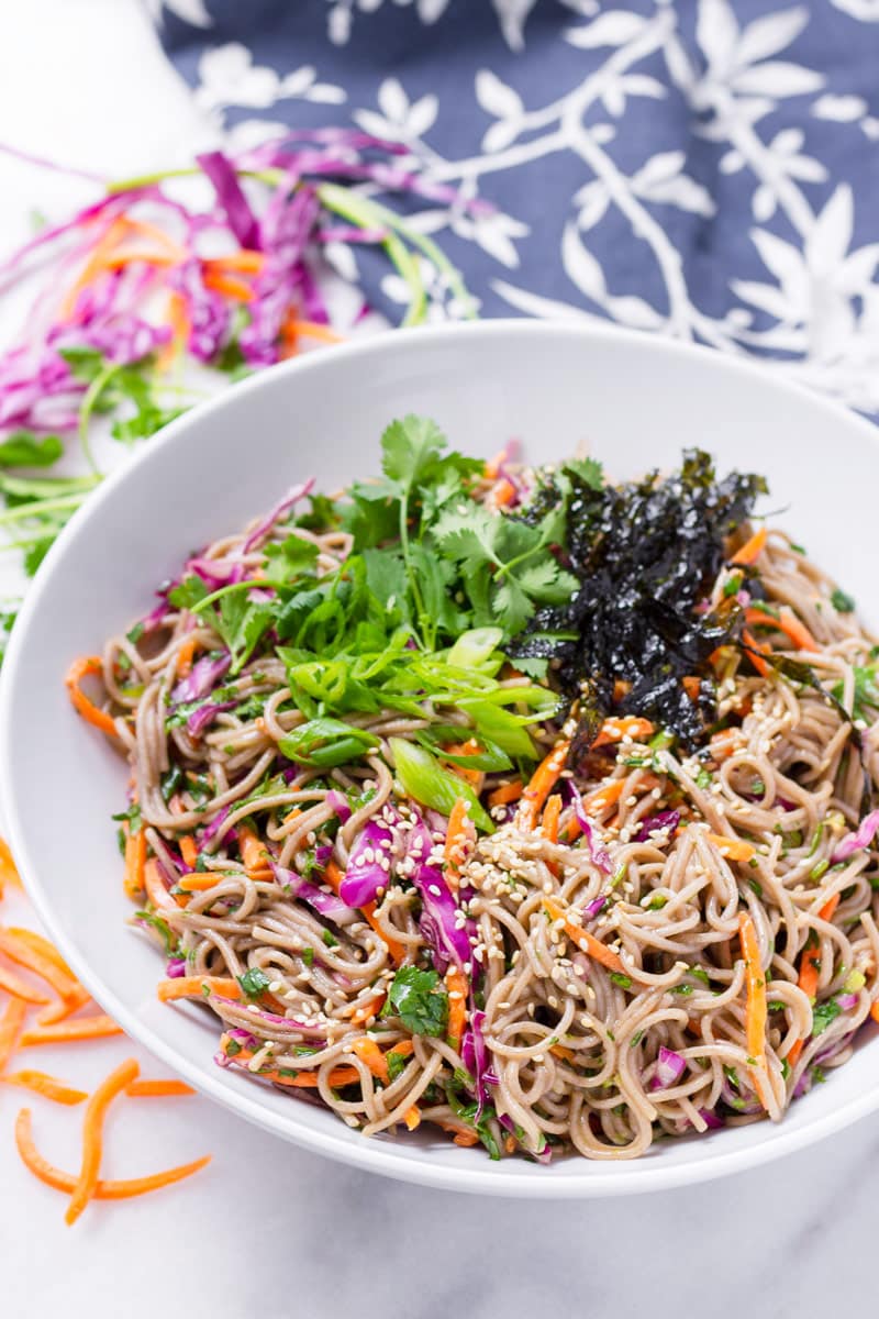cold buckwheat noodle salad with blue floral napkin in background