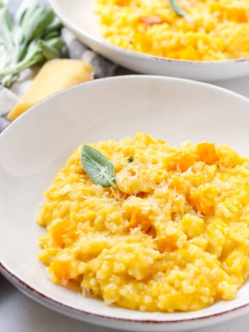 two round bowls with individual servings of butternut squash risotto