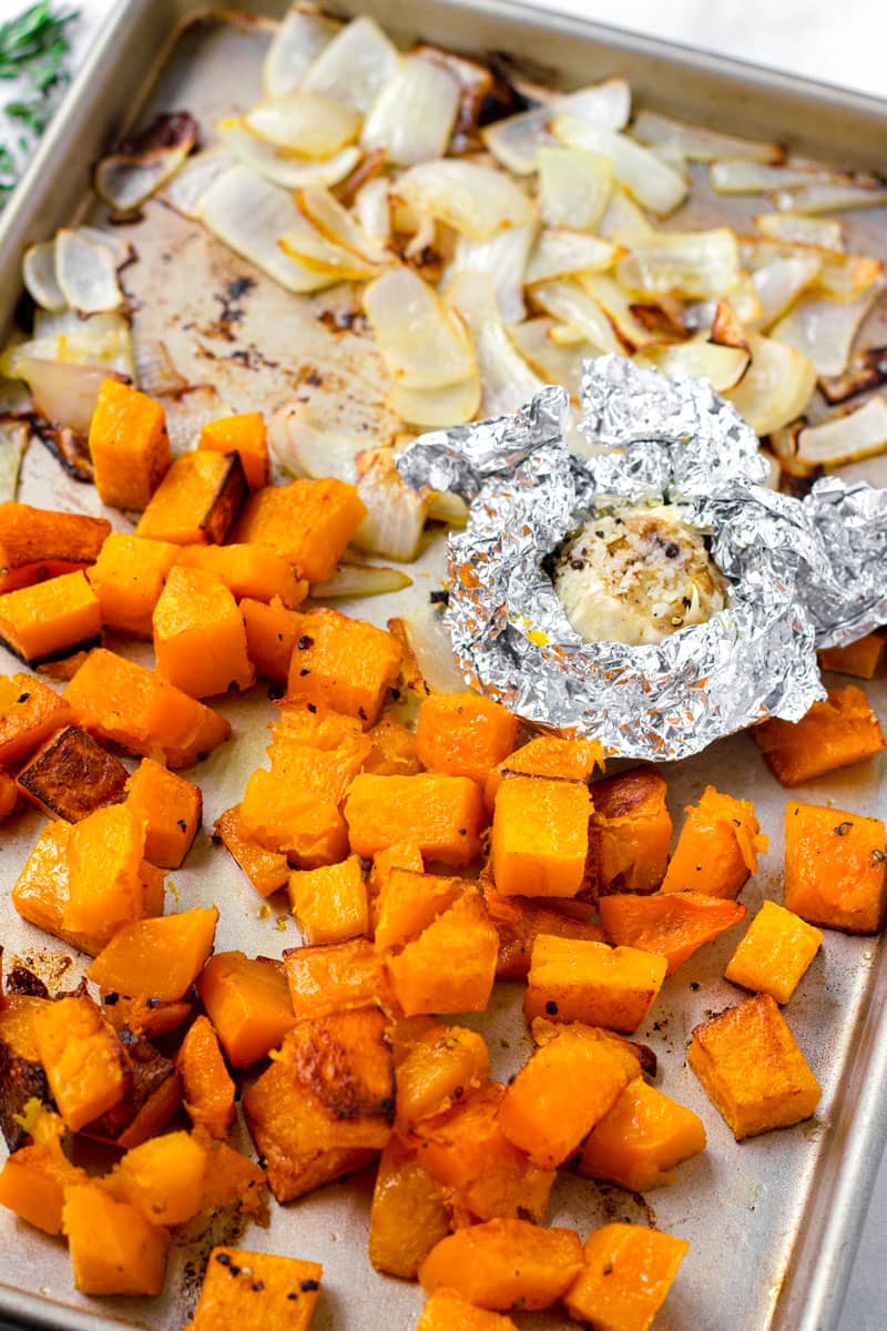 sheet pan with roasted onions, butternut squash, and garlic
