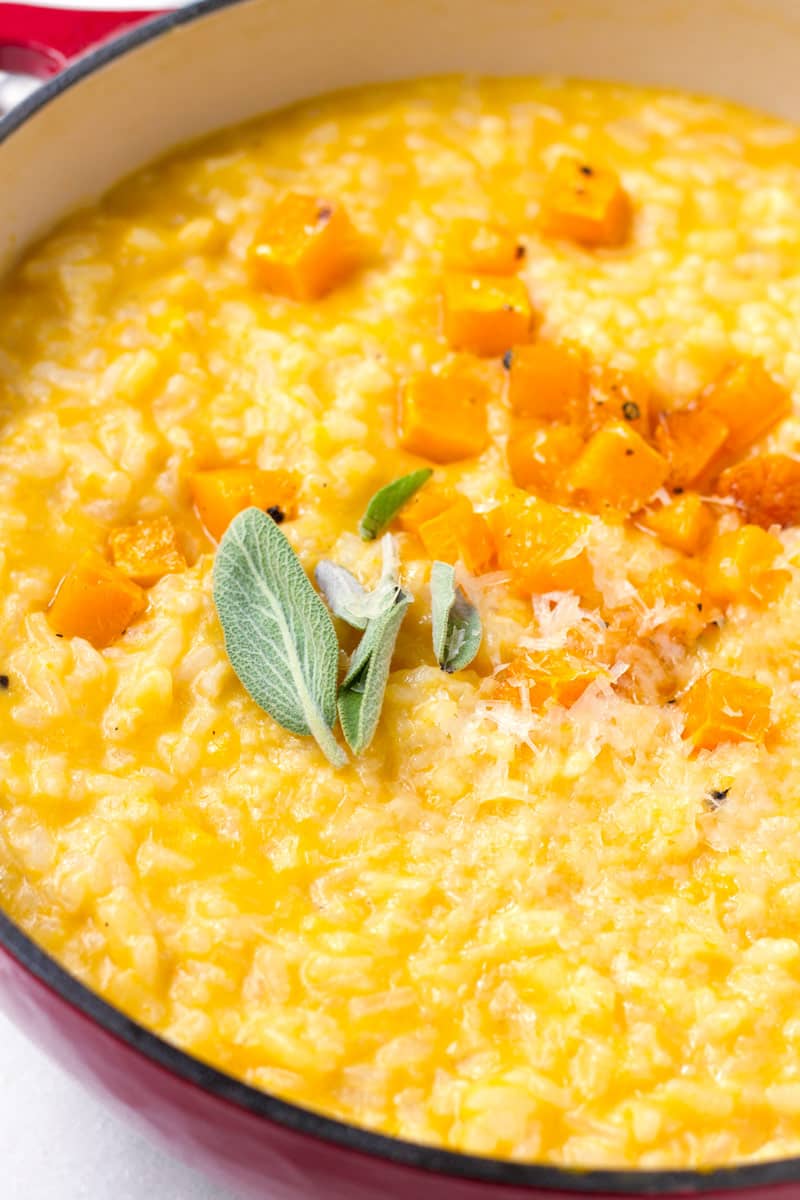 close up view of fall inspired risotto with more butternut squash garnish and sage