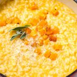 tender butternut squash risotto in a red cast iron pot