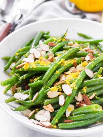 Green bean salad with lemon dressing served in a round white bowl