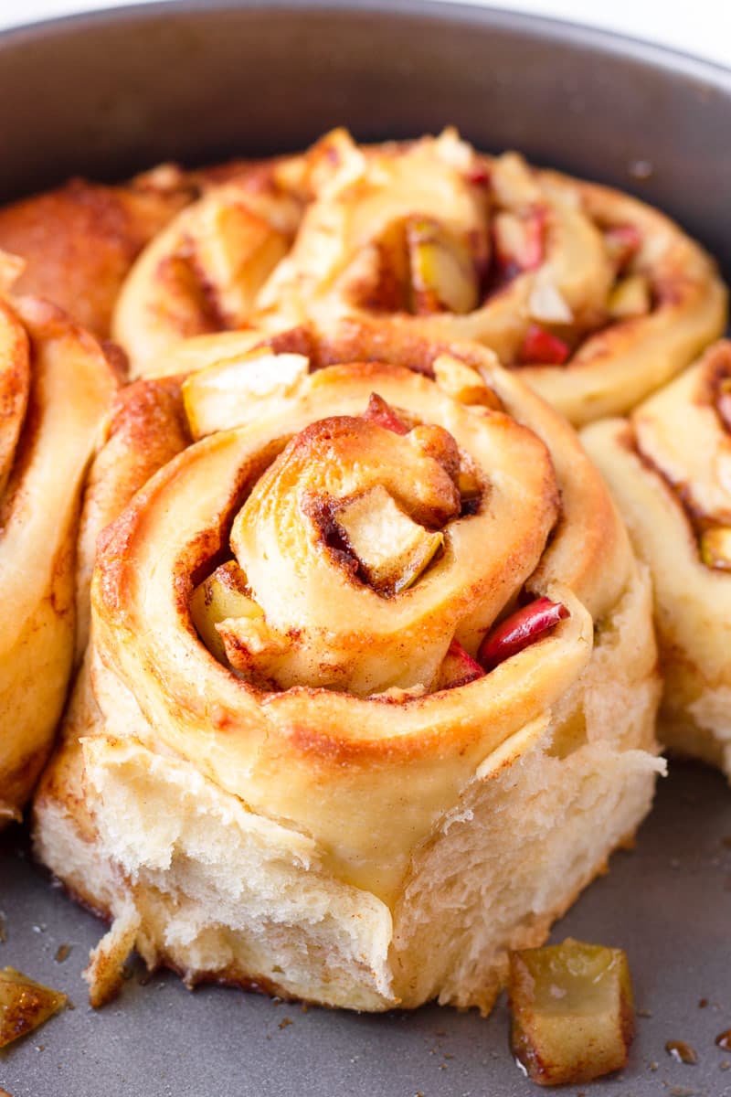 fluffy cinnamon roll with apples on a round pan