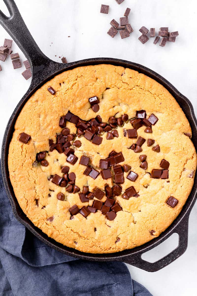 giant skillet cookie next to a blue napkin