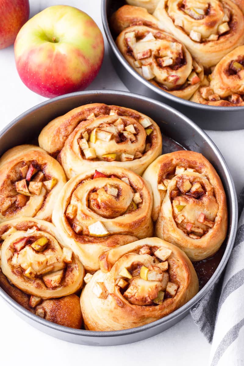 Two round pans with baked apple cinnamon rolls