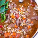 top view of hearty winter soup made with meat, grains, and vegetables