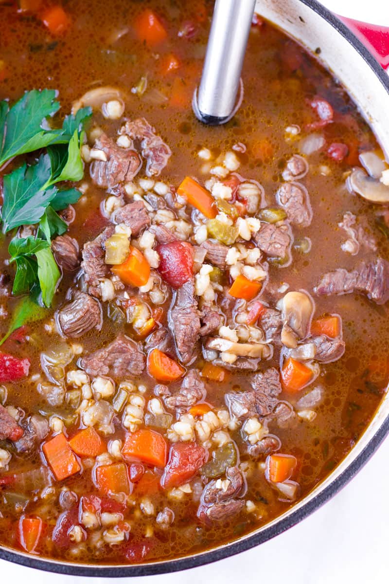 top view of hearty winter soup made with meat, grains, and vegetables