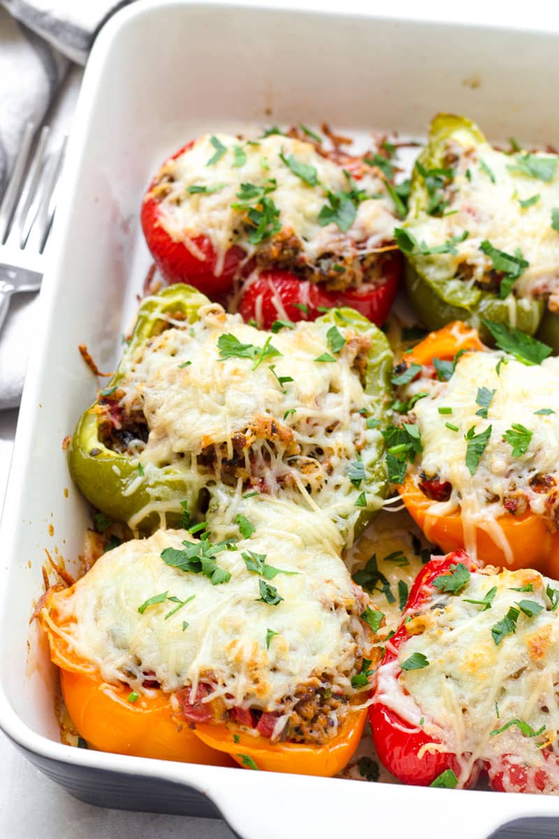 blue baking dish with baked stuffed peppers