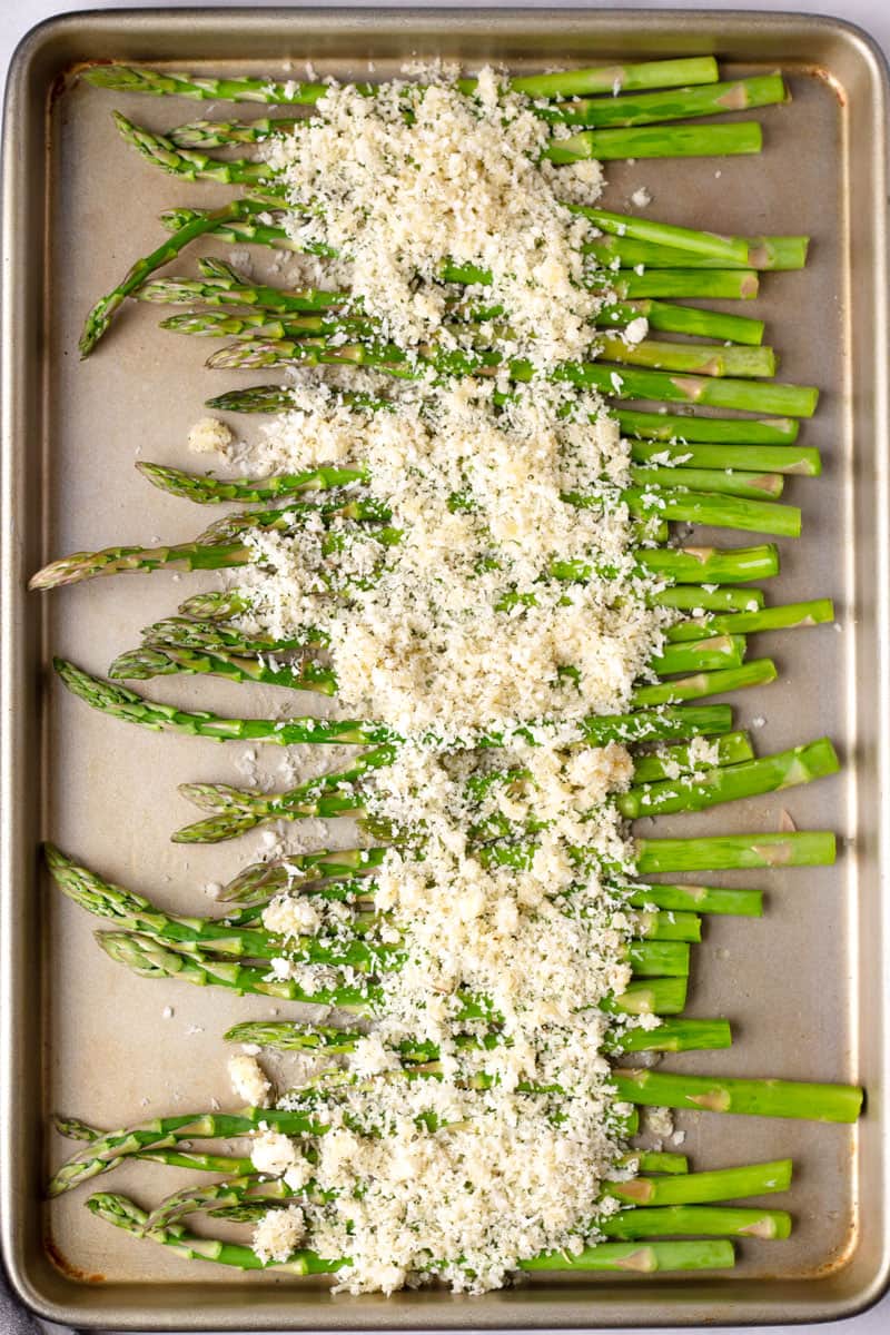raw asparagus in sheet pan prior to baking