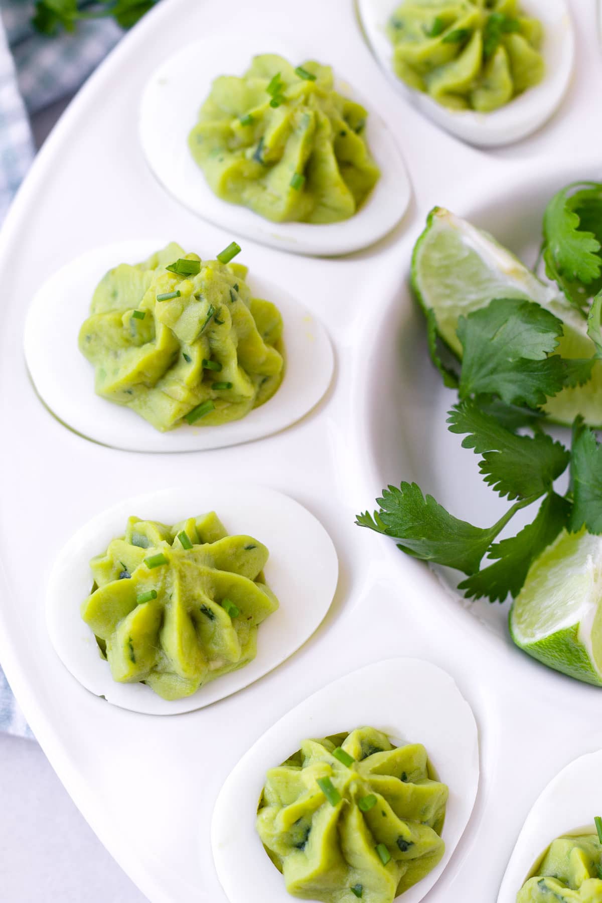 close up of deviled eggs with avocado and egg yolk filling