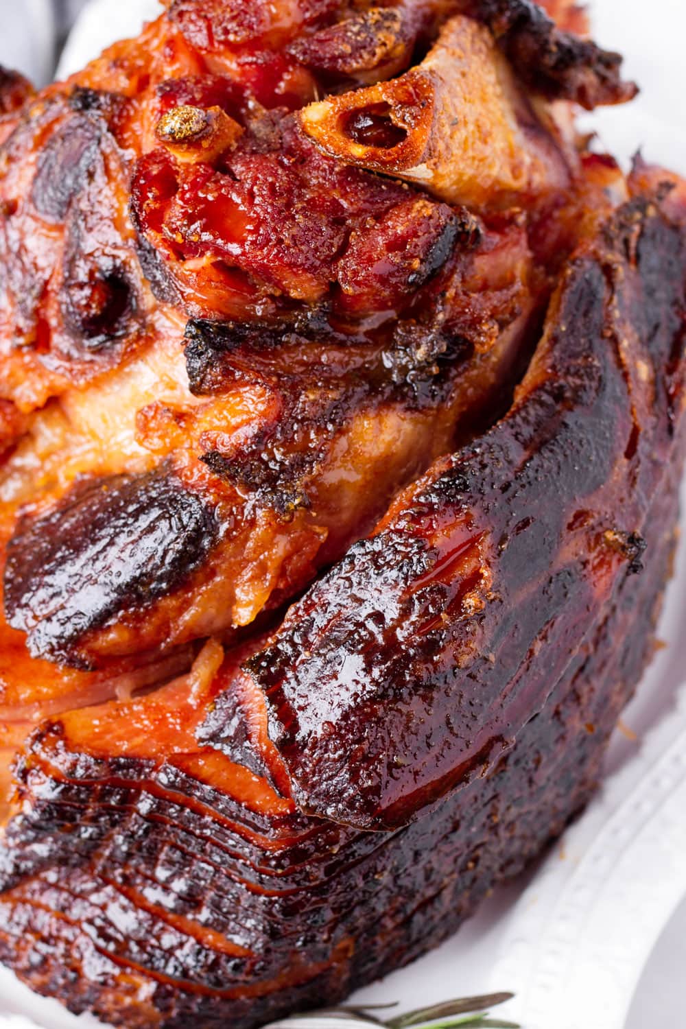 close up of a whole brown sugar caramelized ham with bones
