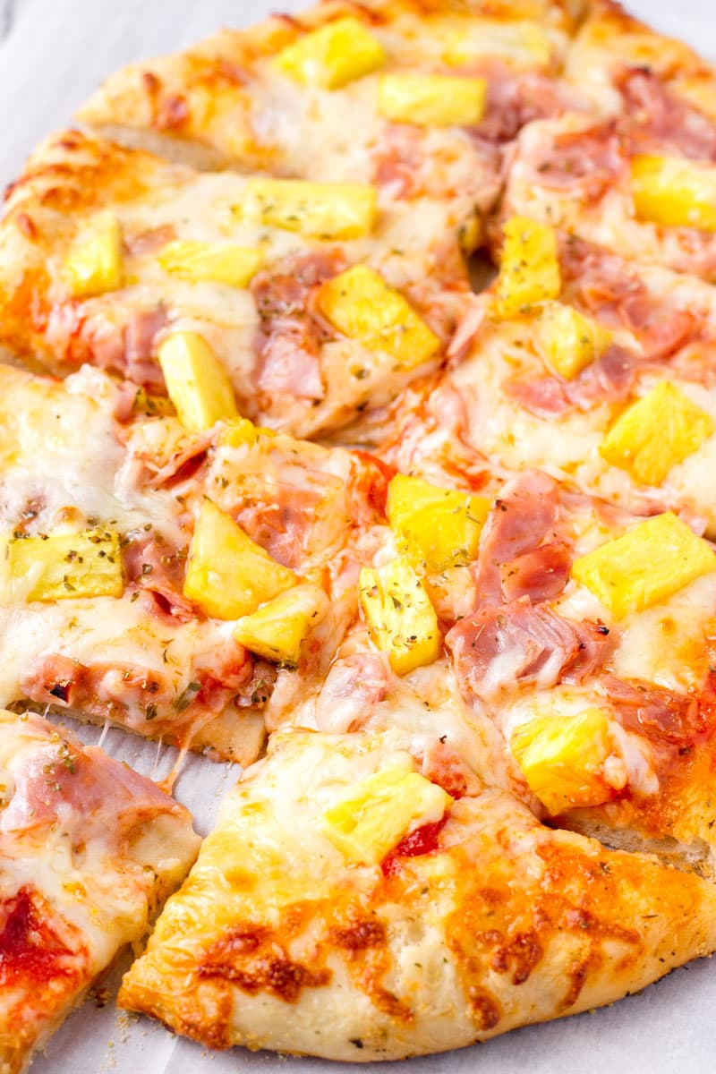 sliced sheet pan pizza with pinapples and ham