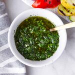 chimichurri sauce in bowl with spoon
