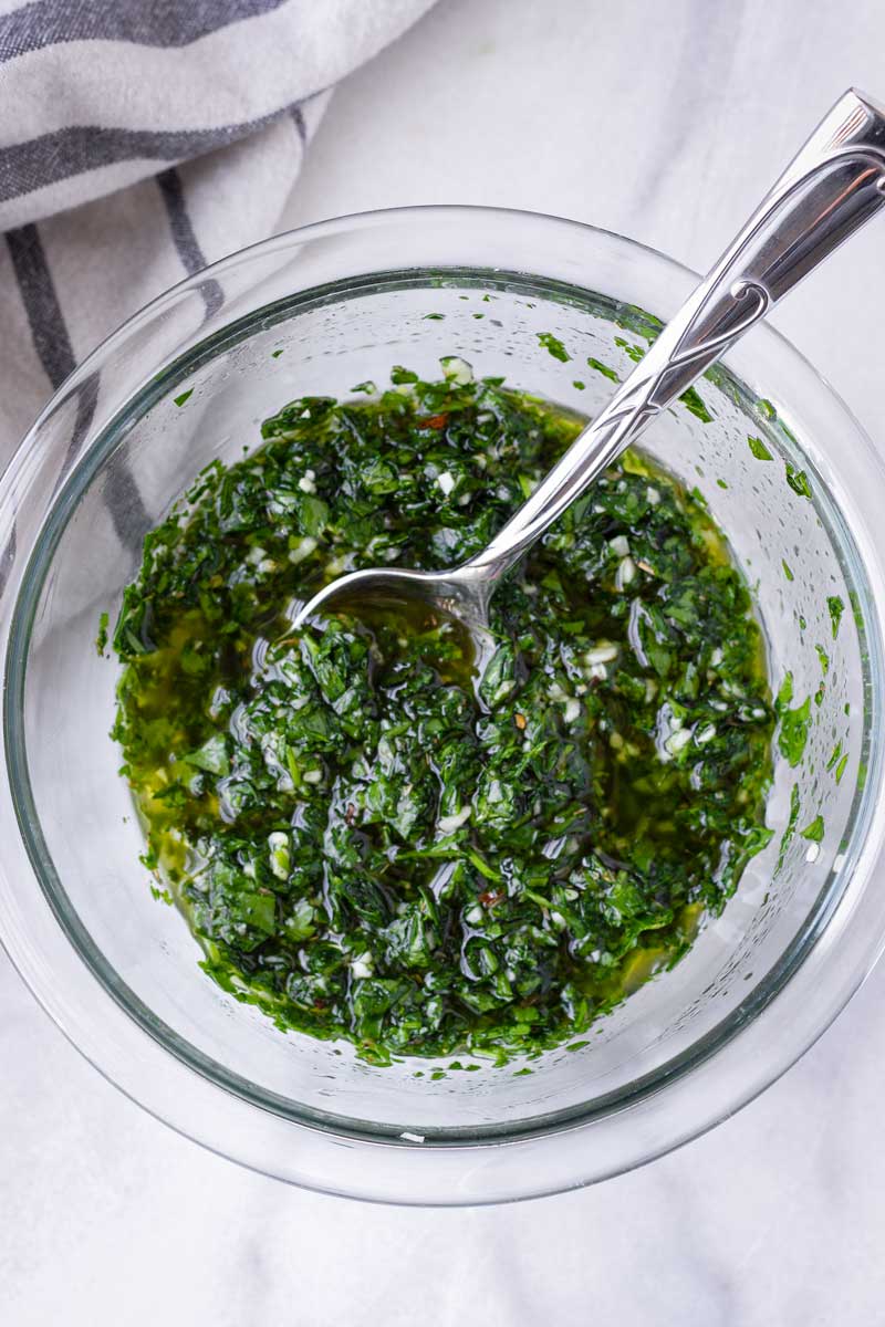 prepared parsley chimichurri in a glass bowl with a spoon