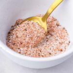 burger spice seasoning blend in a small bowl being scooped out by a spoon