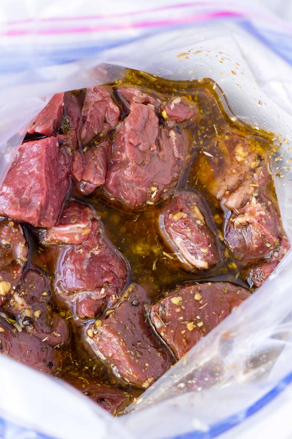 meat in marinade inside a resealable bag