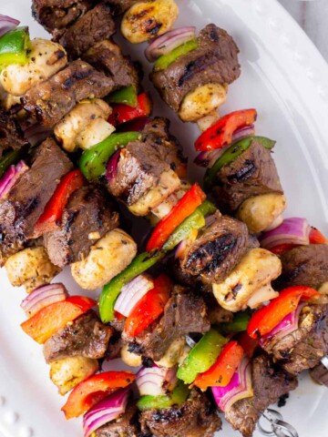 platter with grilled marinated beef kabobs and vegetables