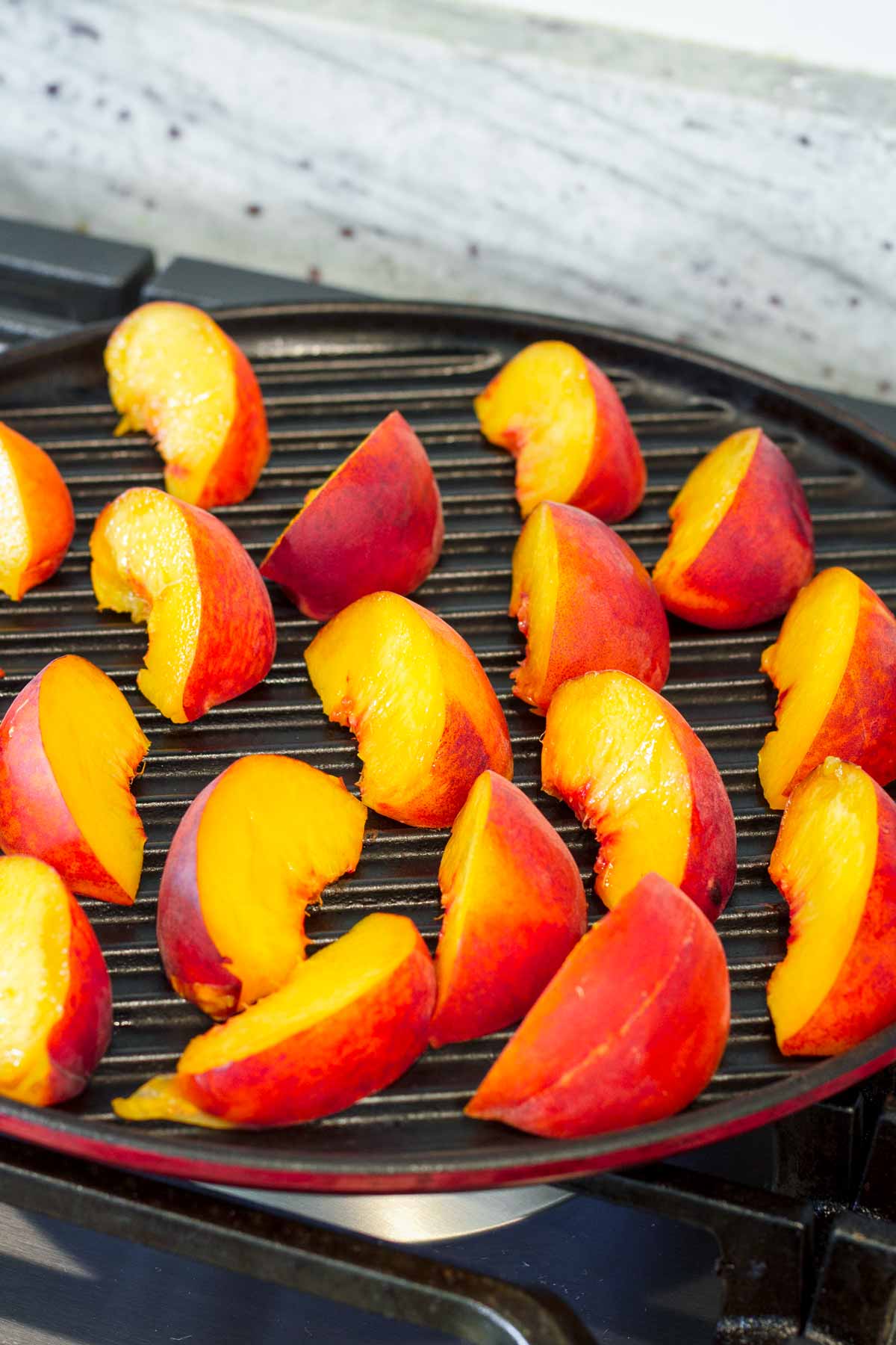 fresh peach wedges on a round grill pan