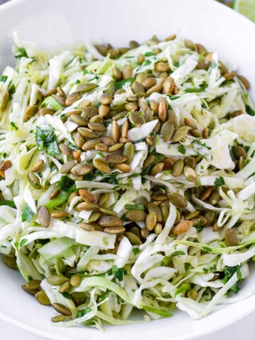 bright mexican slaw salad with pepitas, cumin, and lime dressing