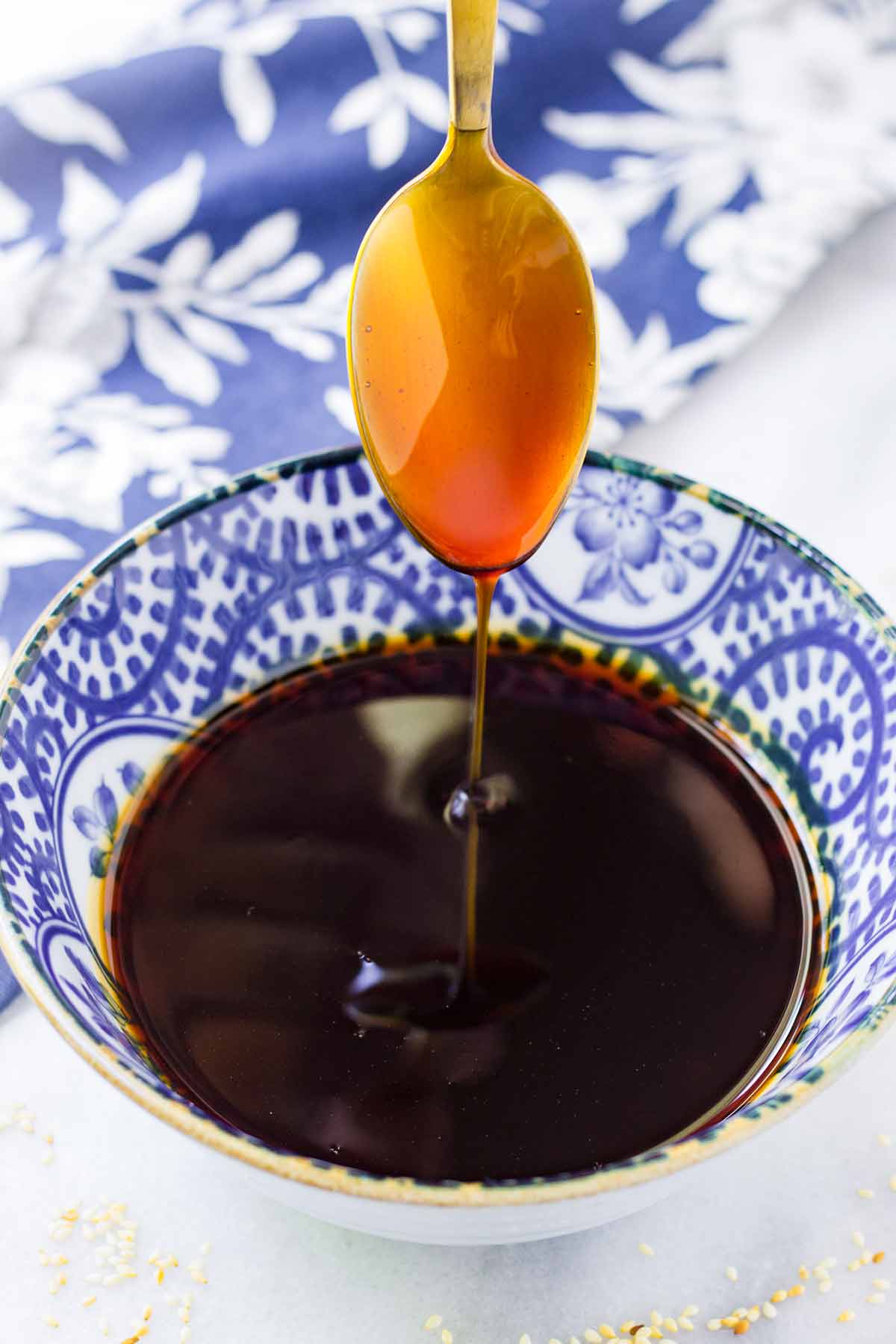 homemade teriyaki sauce dripping from a spoon onto a bowl