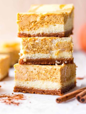 side view of three cheesecake bars stacked on top of each other