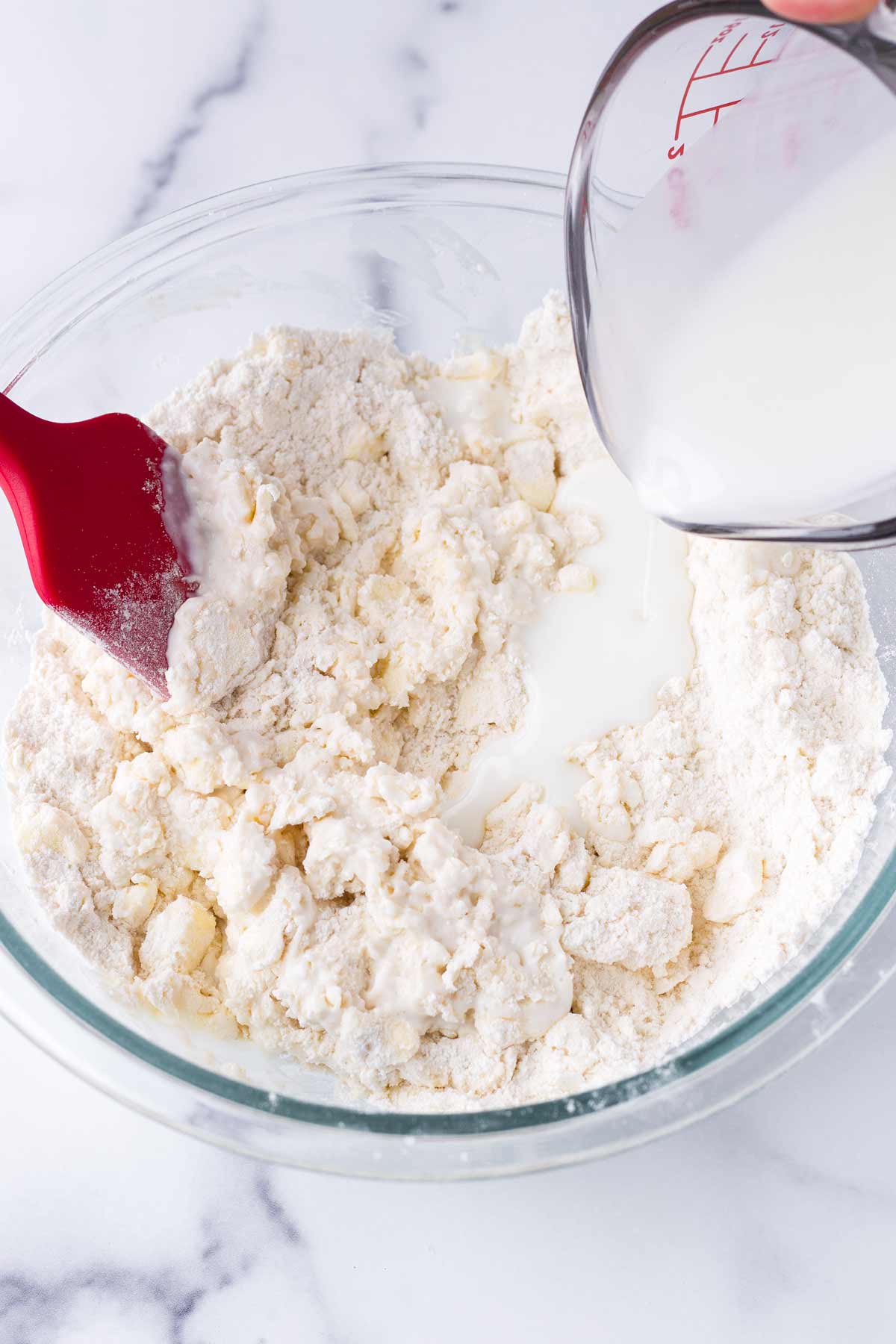 pouring buttermilk into dough