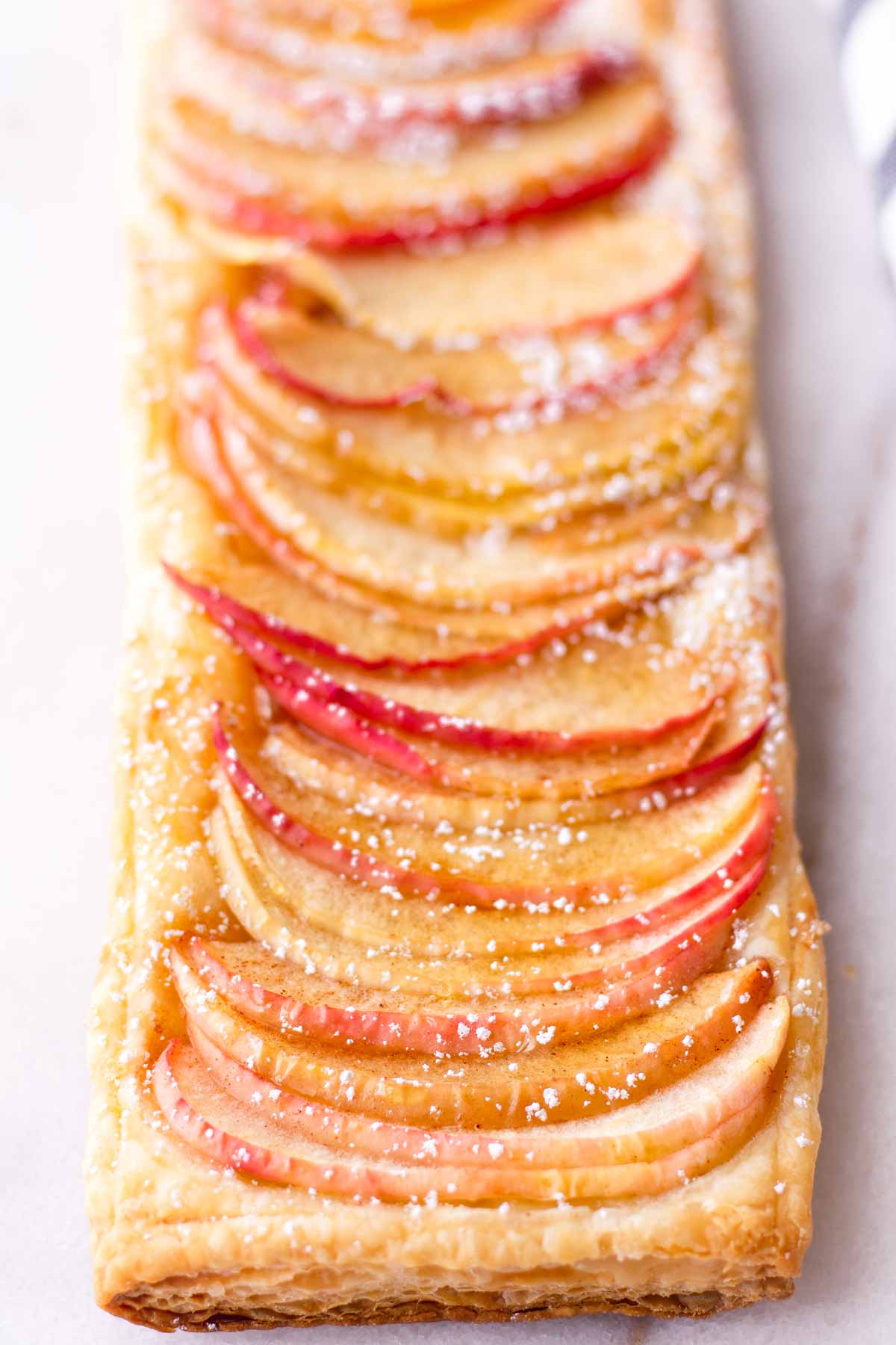 side view of arranged baked honeycrisp apple slices on top of crust