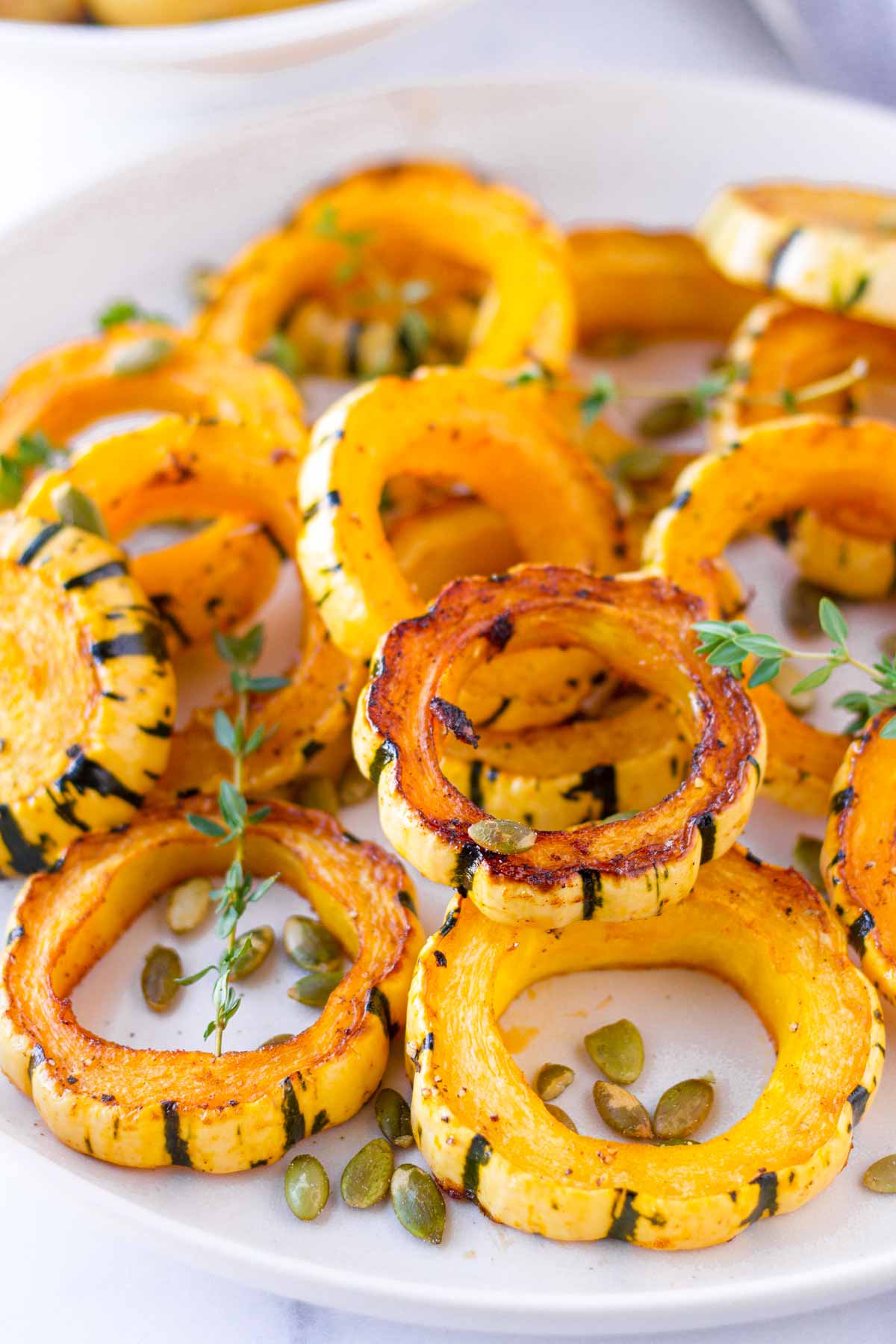seasoned and baked delicata squash on a plate