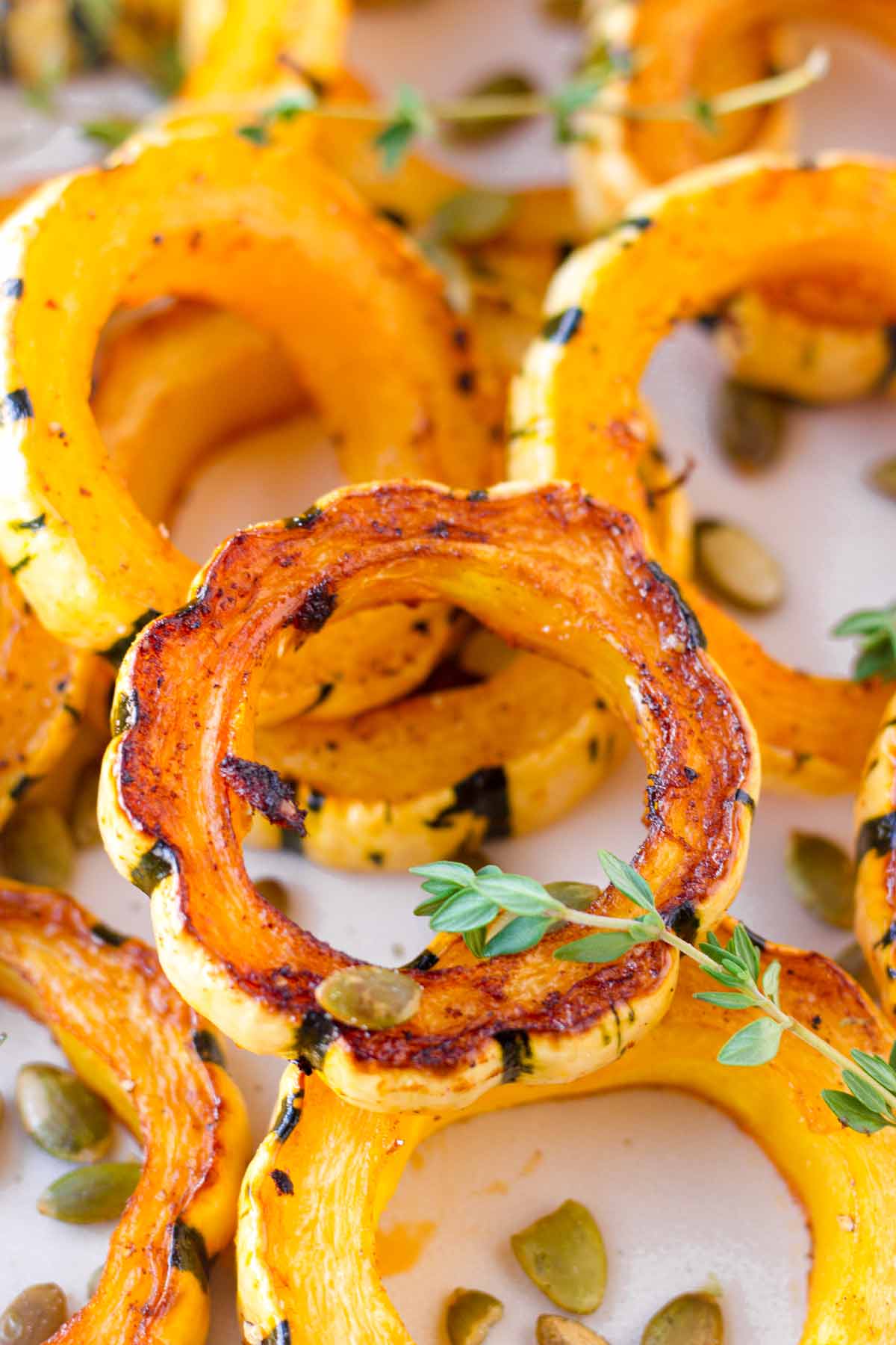 several pieces of roasted delicata squash stacked on top