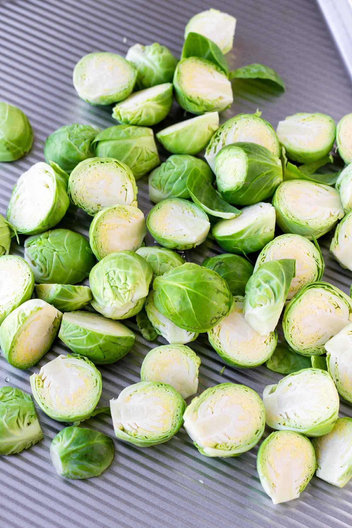 sliced raw brussels sprouts on sheet pan