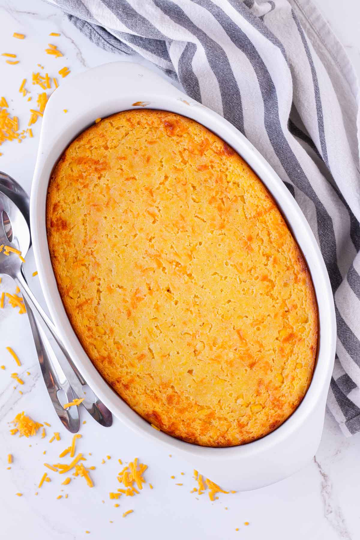 baked golden brown yellow corn souffle in oval pan